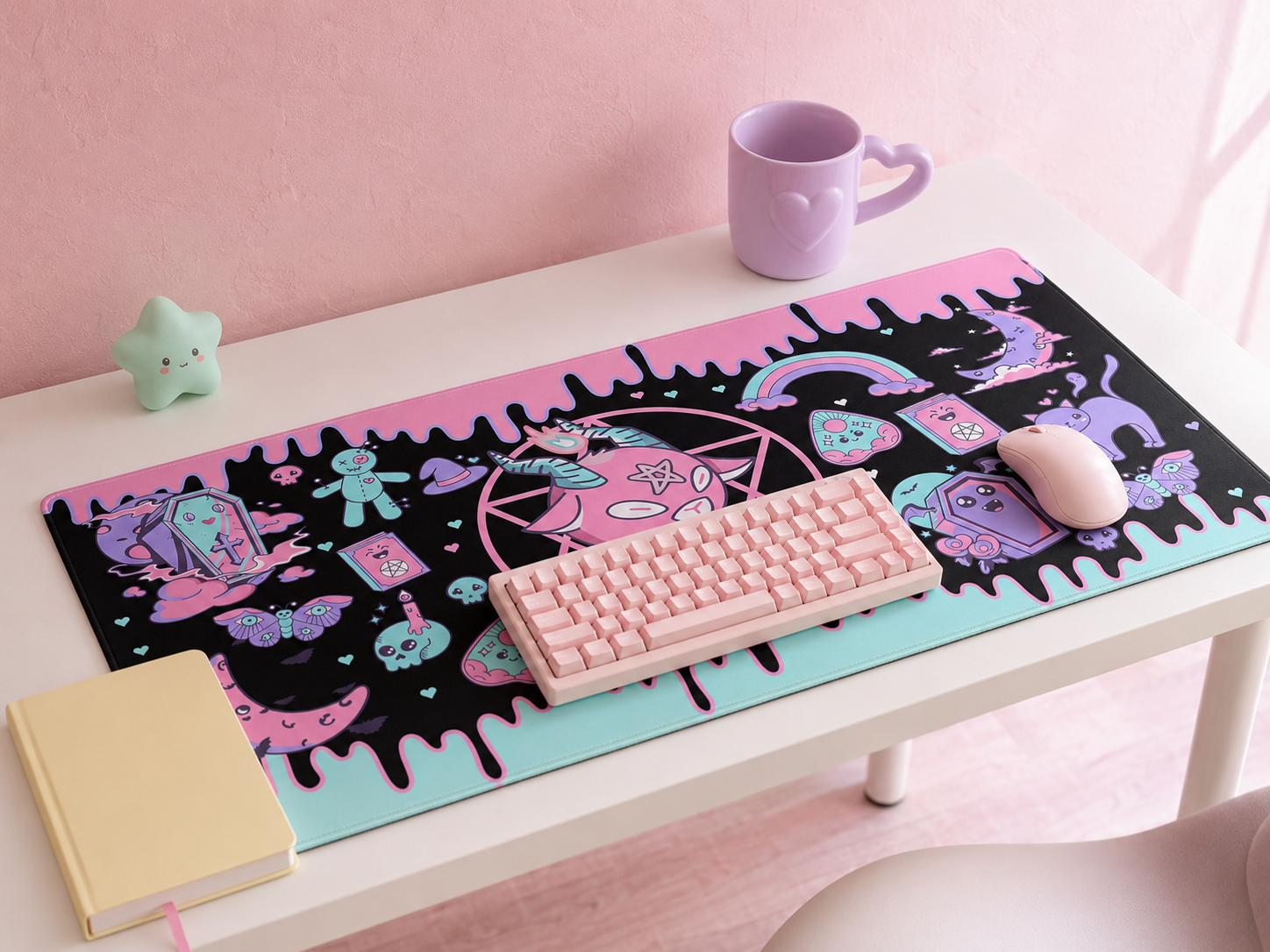 A kawaii desk with a unified pastel color palette featuring an extra-large pastel pink desk mat, pastel keyboard, and matching accessories against a soft pastel pink wall