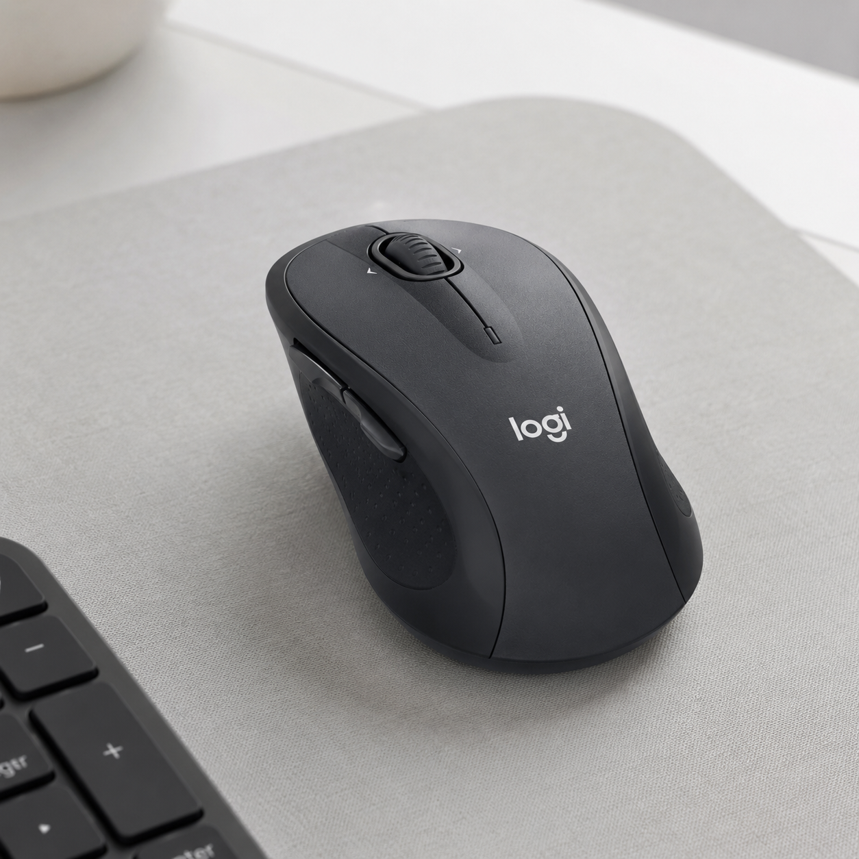 Logitech M510 wireless mouse with a clean neutral finish on a desk mat