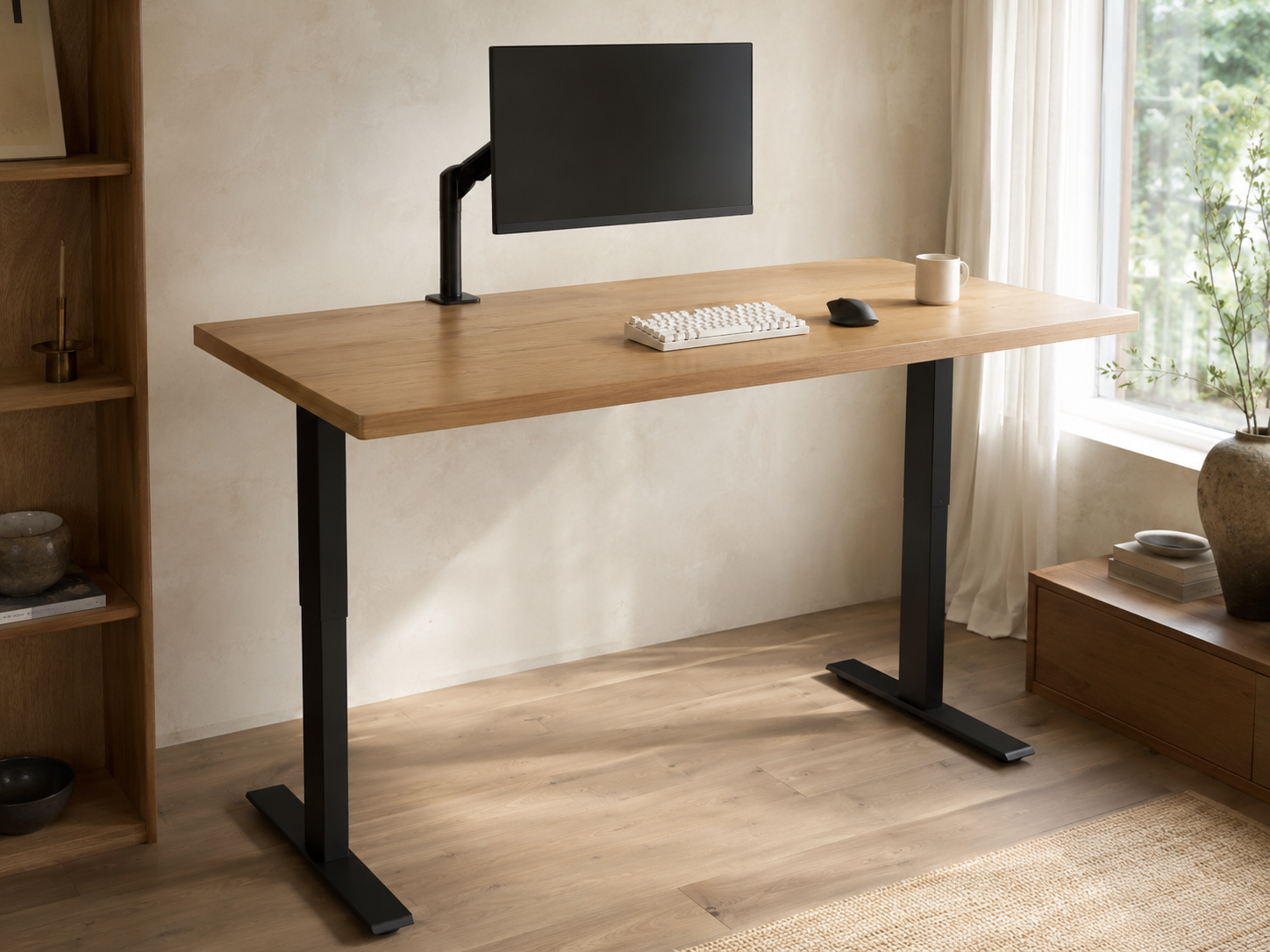 A minimalist standing desk in raised position with a single 27-inch monitor on an articulating arm and a slim mechanical keyboard
