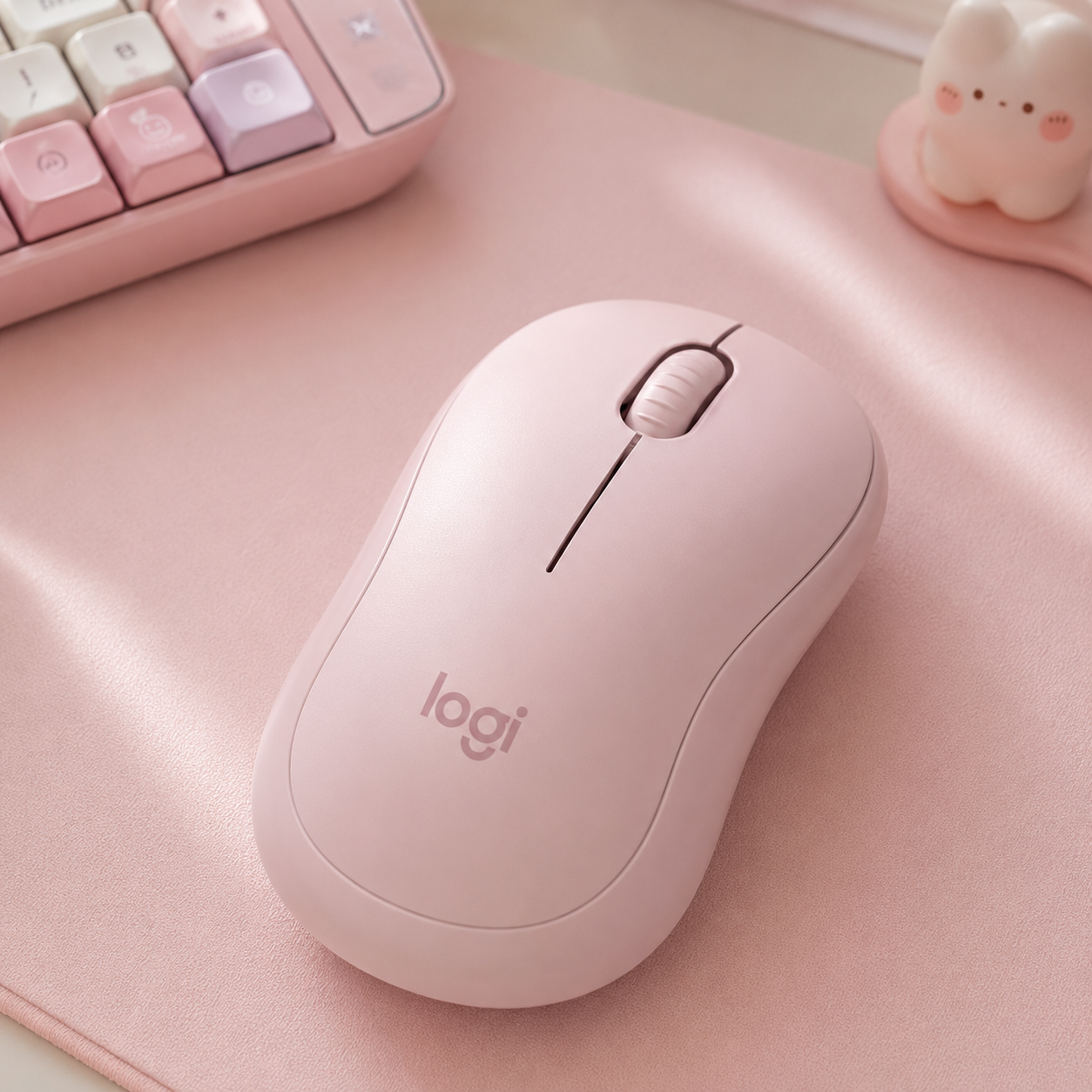 Logitech M240 silent Bluetooth mouse in a soft pastel color on a pastel desk mat