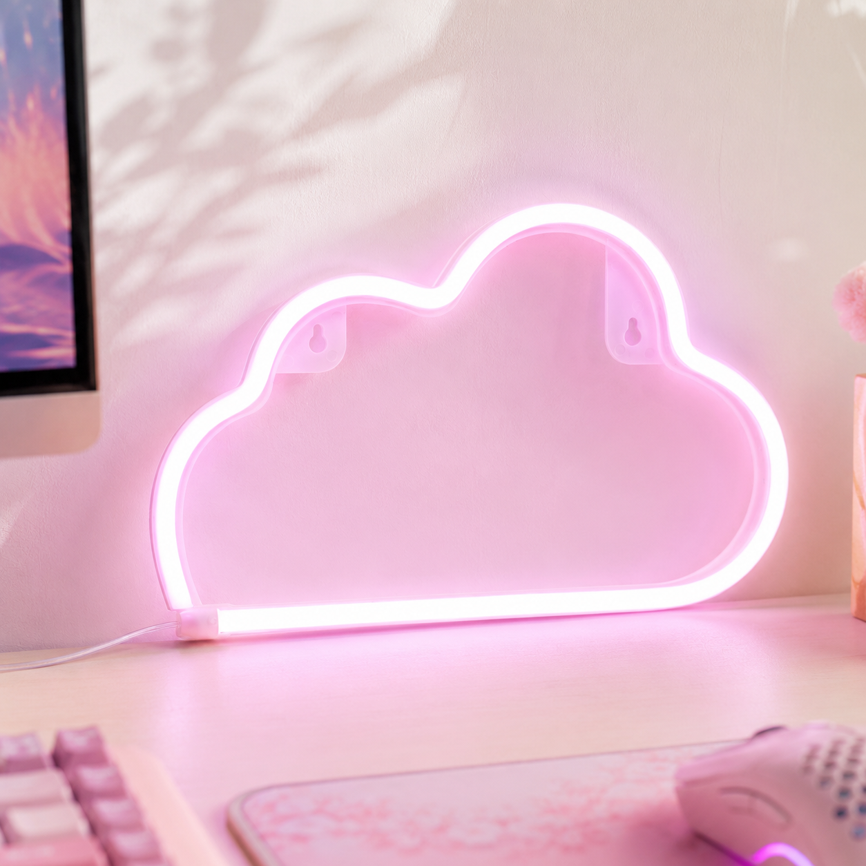 Pink cloud neon sign light for wall decor casting a soft pastel glow